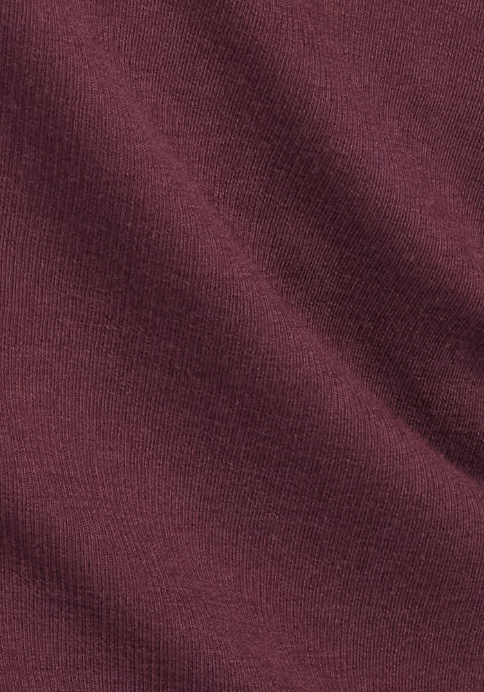 Close-up of the Reese Ribbed Henley in Chocolate Fig by Woolx, showing textured ribbing and soft folds—highlighting its cozy warmth, ideal for a layered shirt or snug women’s top.