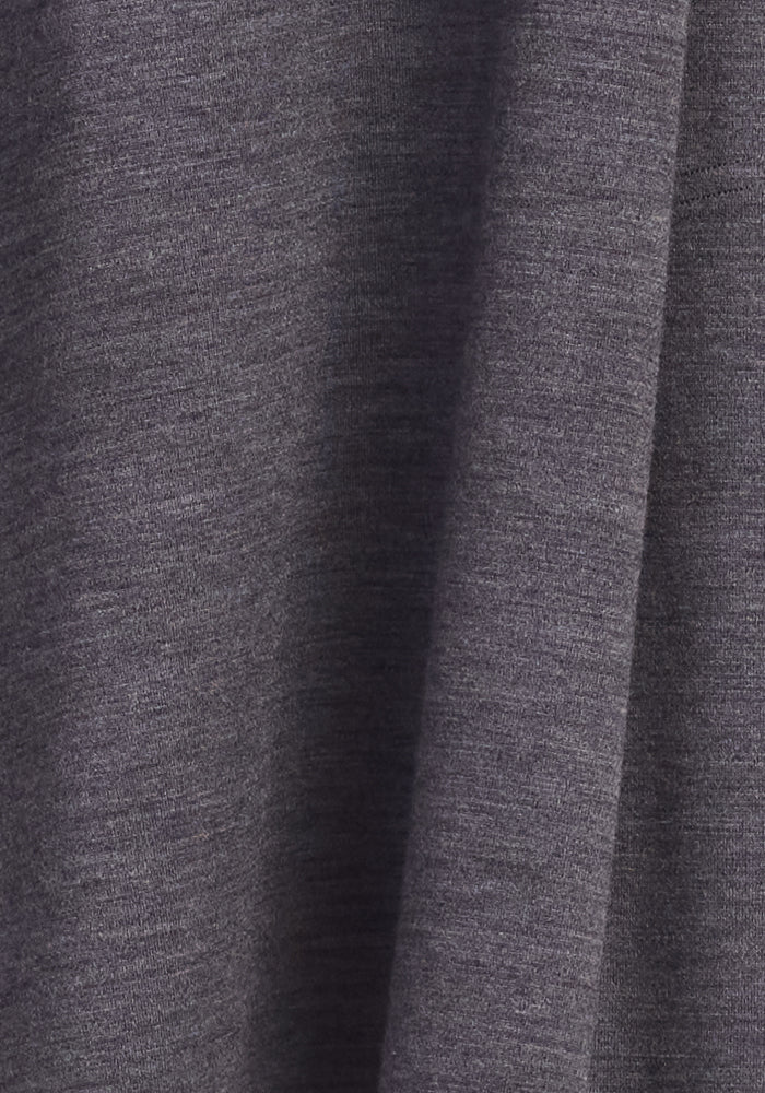Close-up of Clara Dress - Cinder Melange by Woolx, showing gray, slightly textured Merino wool fabric with soft vertical folds that create subtle shadows and depth.