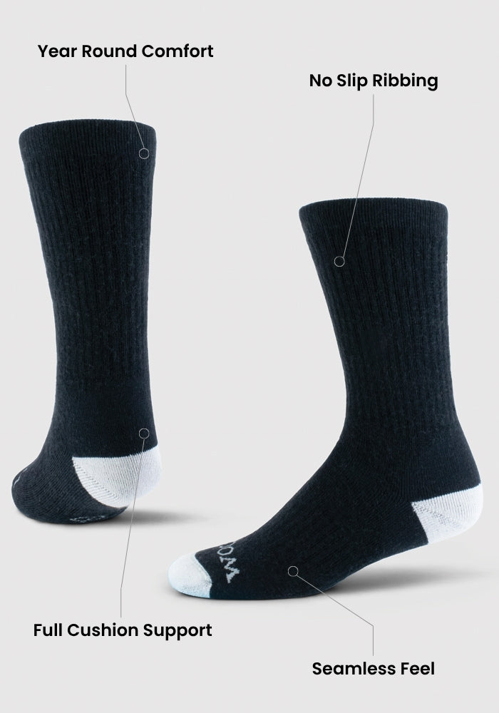 Two Womens Core Crew Socks by Woolx in natural color are shown upright. Features include year-round comfort, no slip ribbing, full cushion support, seamless feel, and moisture-wicking performance fit on a light background.