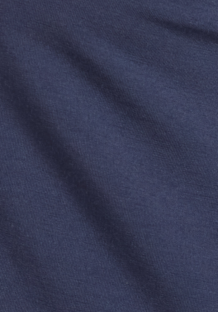 A close-up of the Brynn Pants in Deep Navy by Woolx shows soft, diagonal folds on a slightly textured, woven surface—ideal for heavyweight merino wool comfort and style.