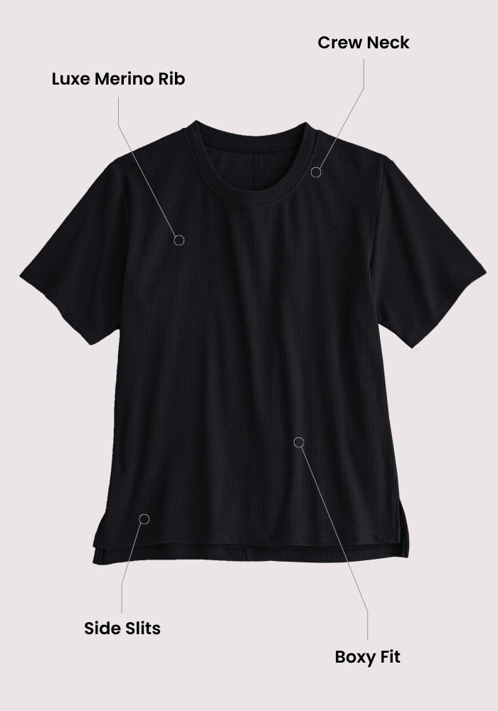 The Woolx Delia Ribbed Short Sleeve - Surfside is a black merino wool top with a crew neck, luxe ribbed fabric, side slits at the hem, and a relaxed fit, shown against a light background.