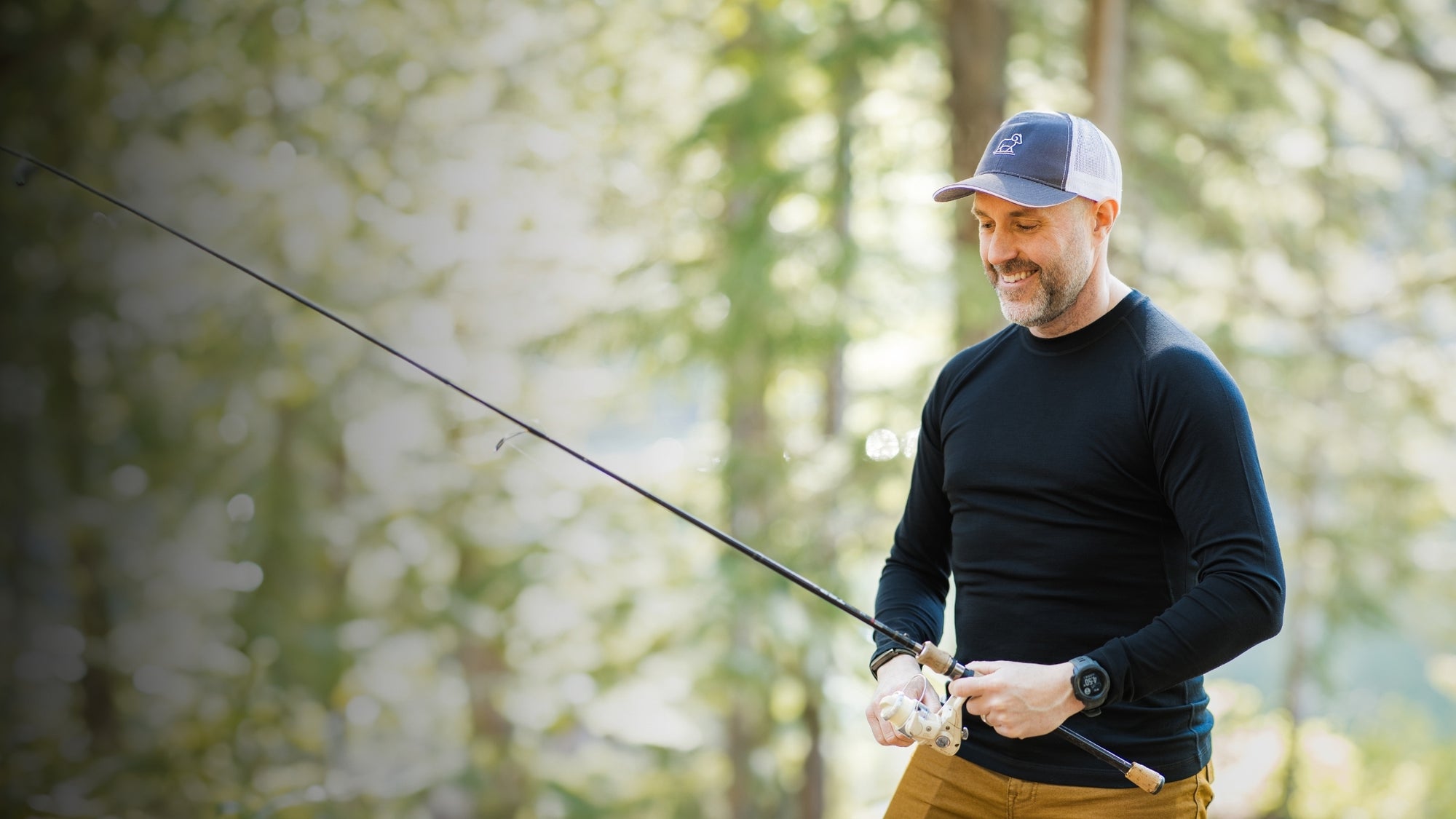 Man fishing in a forested area