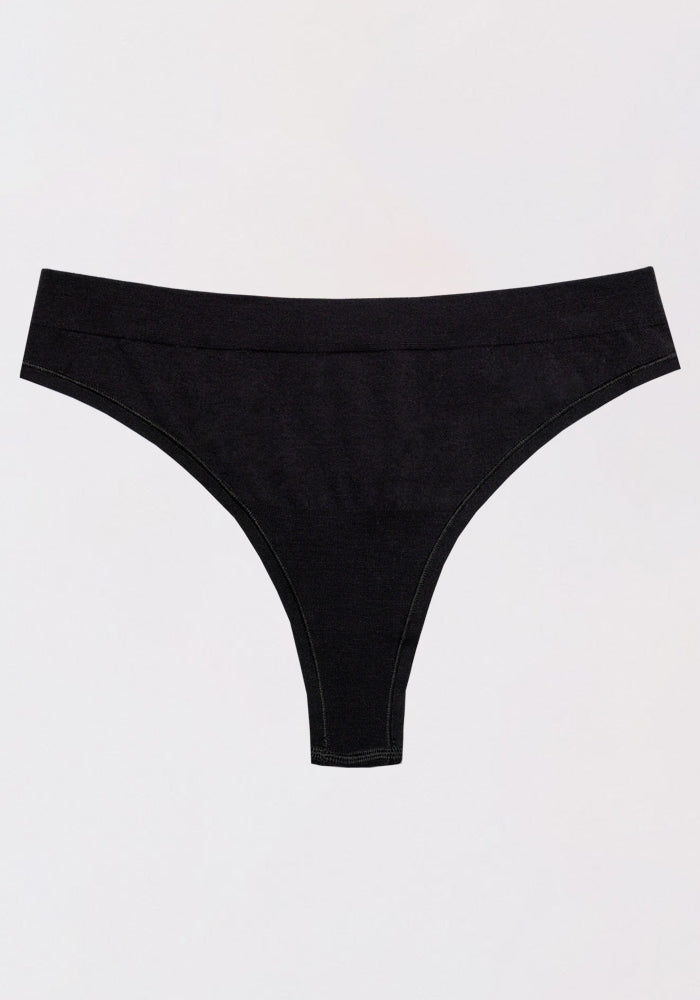 The Woolx Farrah Thong in black is laid flat against a plain, light-colored background.