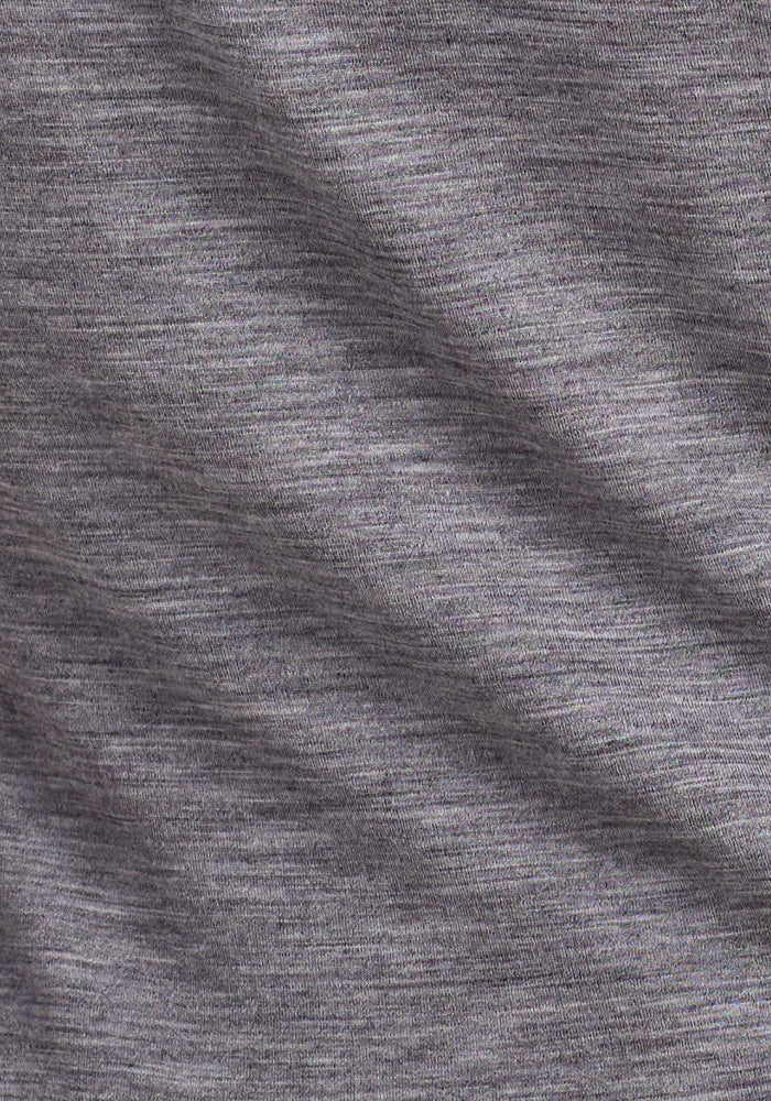 Close-up of the Woolx Millie Long Sleeve in Graphite Heather, featuring soft Merino wool fabric with fine horizontal lines, subtle gray variations, a slightly textured surface, and temperature-regulating properties.