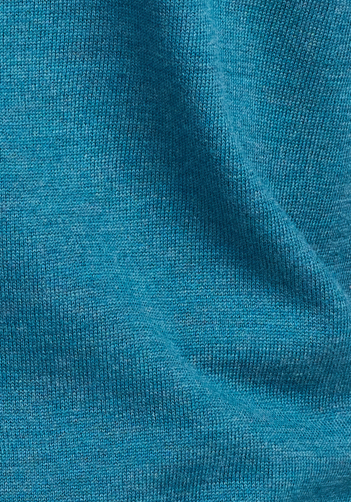 Close-up of the Woolx Francesca Sweater in Harbor Teal, with visible knit texture and fine stitching, showcasing the moisture-wicking fabric and soft folds.