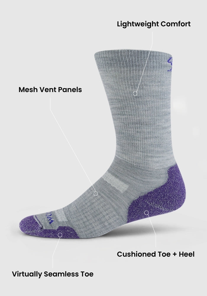 The Woolx Womens Harbor Crew Sock in Grape Harvest is shown with labels highlighting its lightweight cushioning, mesh vent panels, cushioned toe and heel, moisture-wicking Merino wool, and a virtually seamless toe.
