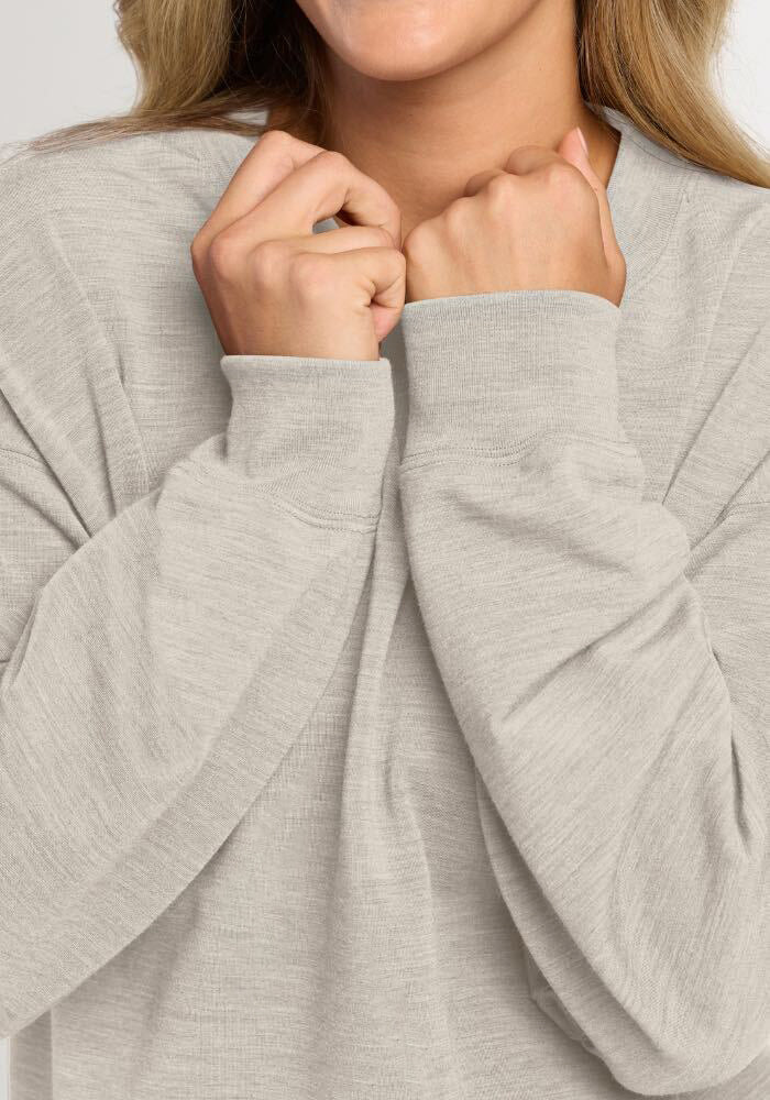 Person in a Light Ash Molly Crewneck pulling the neckline up to their chin.