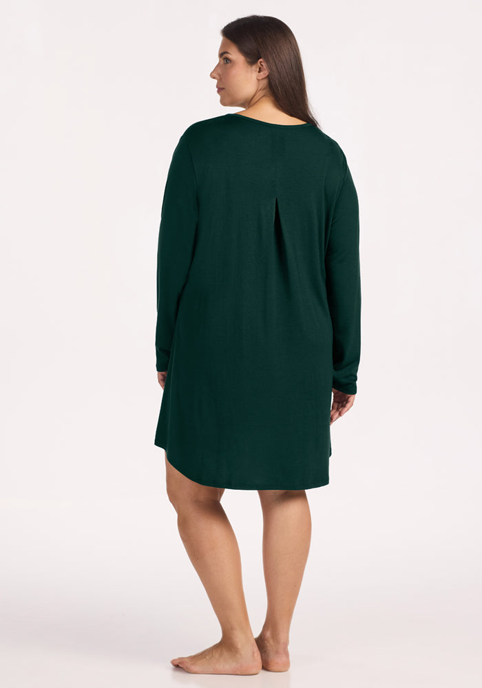 Back view of a woman wearing a deep pine Woolx Lucille Long Sleeve Nightgown with a back pleat.