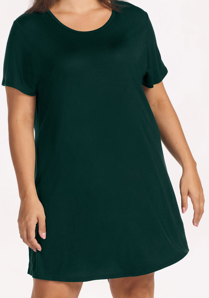 A person wearing a short-sleeved, deep pine Woolx Desi Nightgown in merino wool with a scoop neckline.