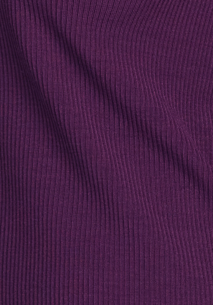 Close-up of the Woolx Evie Ribbed Tunic in Majestic Purple, featuring textured Merino wool with subtle folds—an ideal cozy women’s top for cool days.