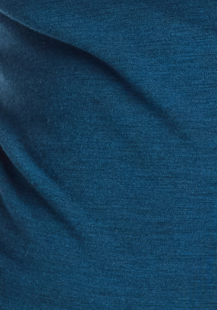 Close-up of Majolica Blue fabric with visible texture and gentle folds, highlighting the soft draping and moisture-wicking comfort of Woolx Piper Pocket Leggings, designed as a women's baselayer in merino wool.