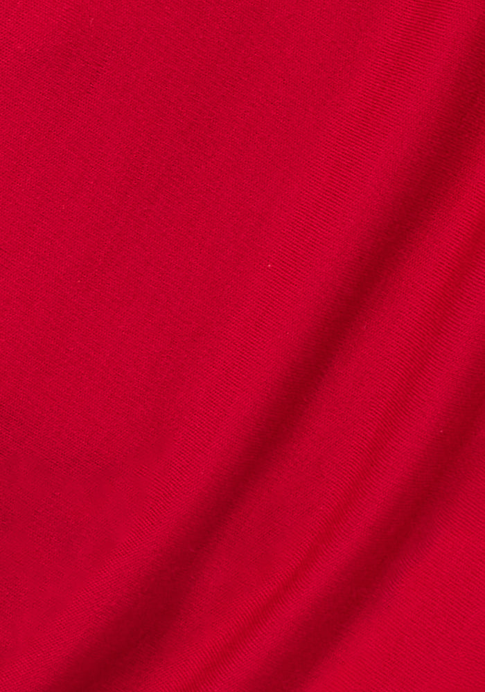 Close-up of the Woolx Hannah Long Sleeve Top in Maraschino Cherry, highlighting the merino wool’s visible texture, gentle folds, and soft drape that showcase its temperature-regulating properties.