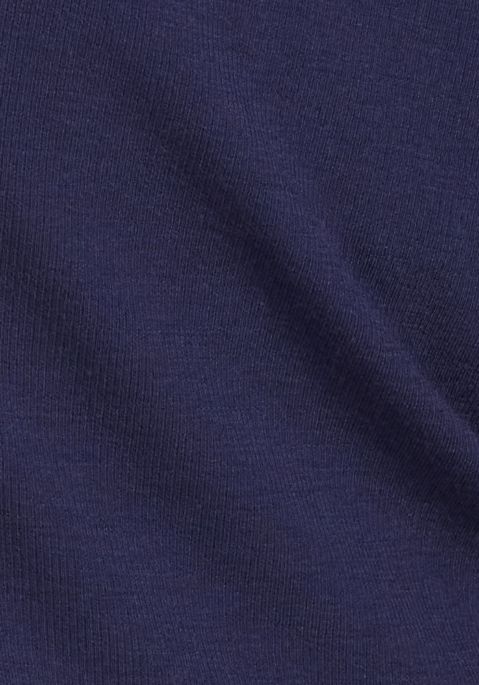 Close-up of the Sage Ribbed Turtleneck in Midnight Sapphire by Woolx, showing dark blue merino wool ribbing and soft folds—ideal for women’s cold-weather wear.
