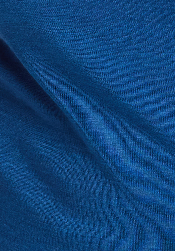 Close-up of the Woolx Hannah Long Sleeve Top in Nightfall, highlighting its soft blue merino wool, fine weave, and smooth texture—perfect for temperature-regulating comfort.