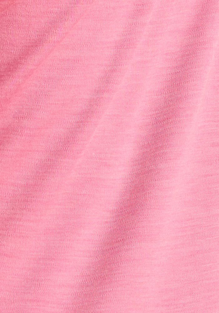 Close-up of the Woolx Kids Explorer Base Layer Top in Pinky Promise, showing its soft Australian Merino wool fabric with subtle diagonal creases and a slightly heathered texture.