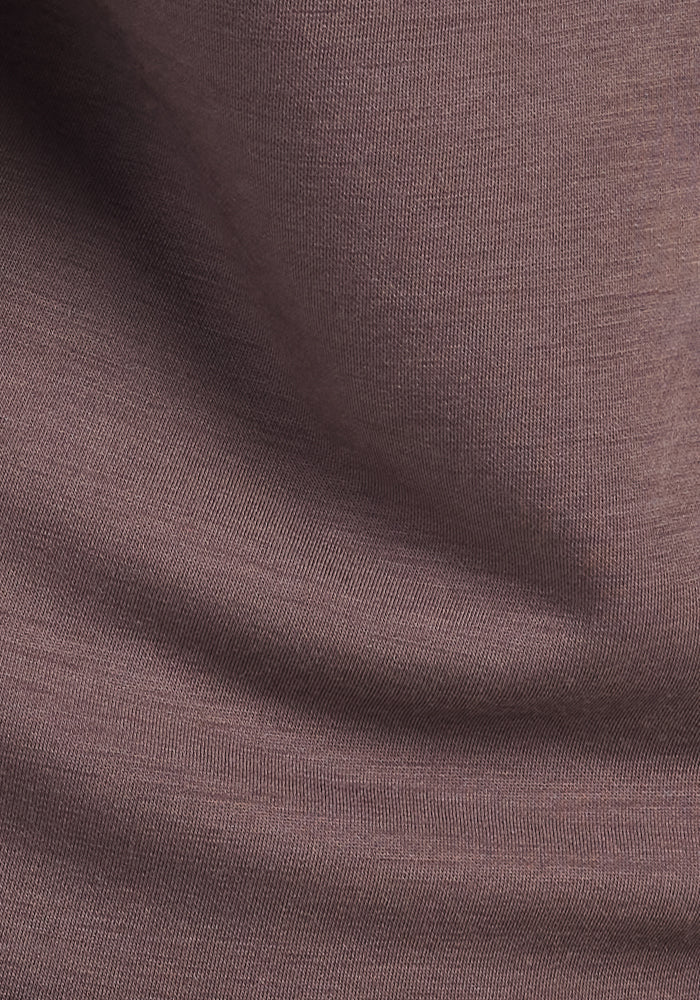 Close-up of soft, brown Plum Truffle fabric with gentle folds and a smooth, slightly textured surface—perfect for Woolx Parker Sweatpants, offering natural temperature regulation and comfort.