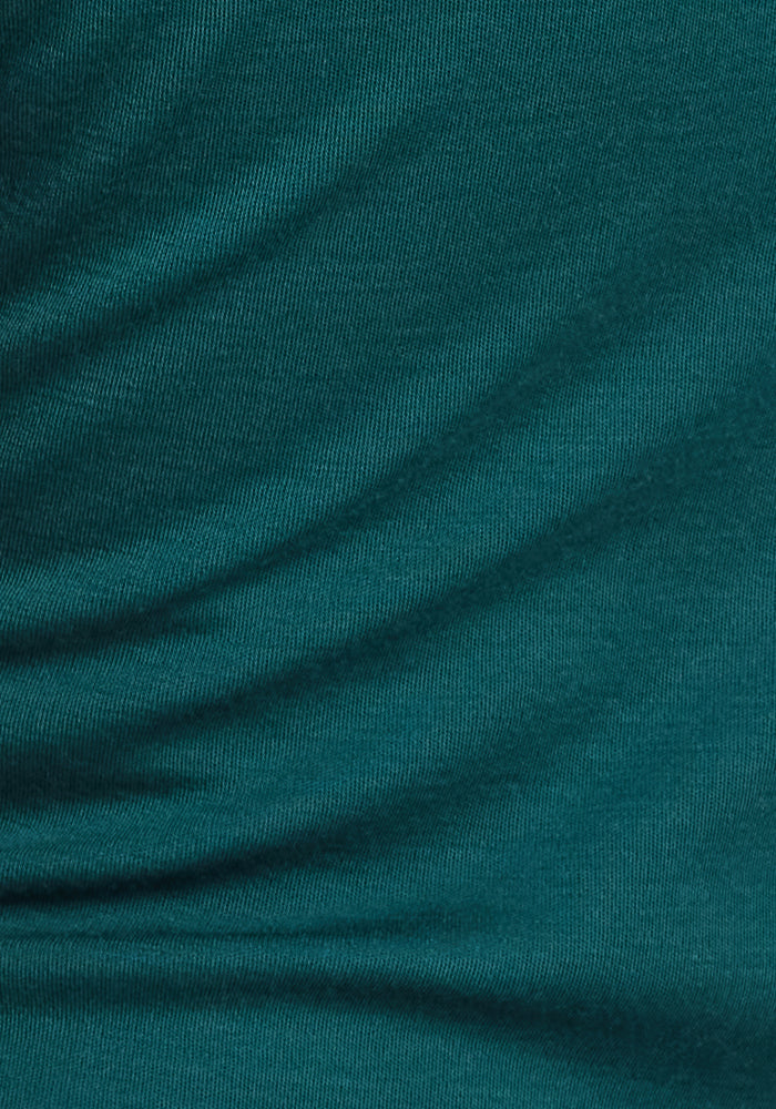 Close-up of the ultra-soft Woolx Callie Hoodie in Riverbank Green, featuring gentle diagonal folds, a soft textured surface with a subtle sheen, and visible weave—perfect for cold-weather layering.