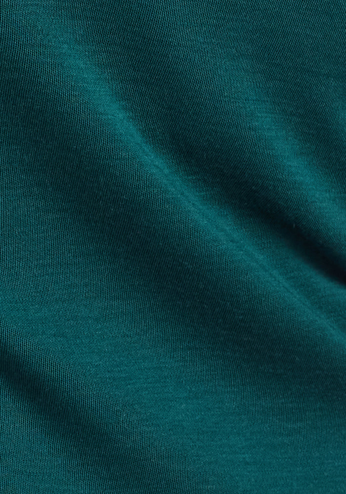 Close-up of the Hannah Long Sleeve Top by Woolx in Riverbank Green, showing its soft, moisture-wicking fabric with subtle horizontal lines and gentle folds for a smooth textured look.