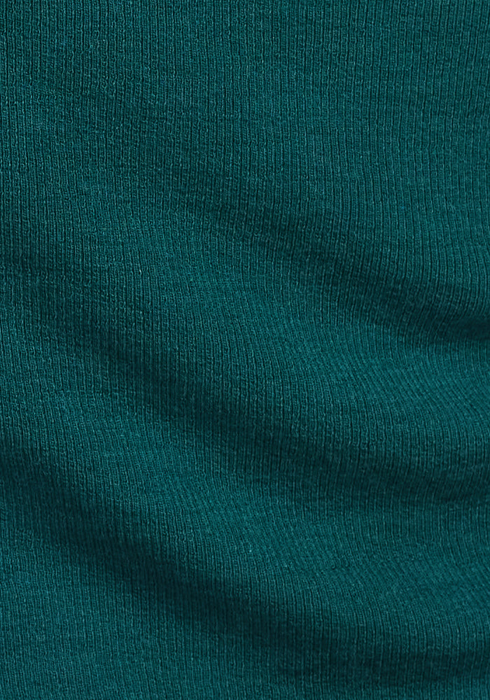Close-up of the Woolx Reese Ribbed Henley in Riverbank Green, highlighting its wavy ribbed texture, vertical lines, and fine knit details.