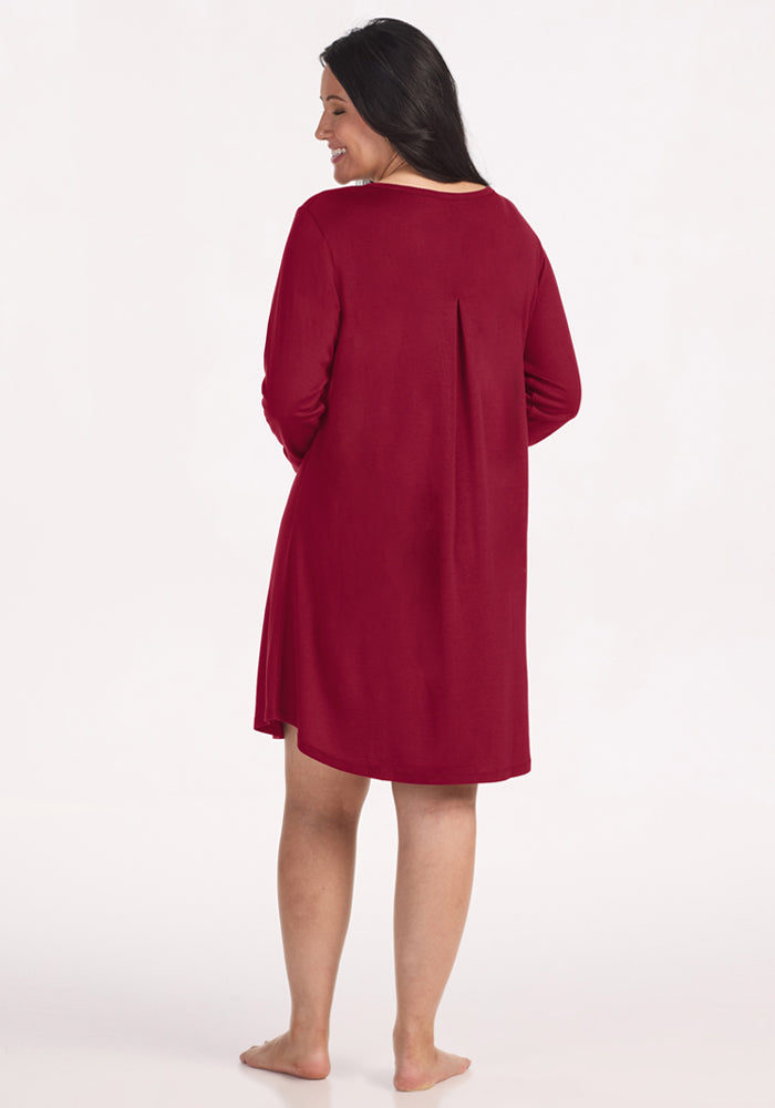 A woman seen from behind wearing a beet red Woolx Lucille Long Sleeve Nightgown with a pleated back detail.