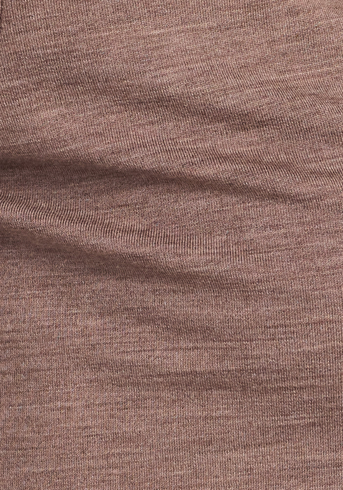 Close-up of the Edna Hooded Cardigan by Woolx in Simply Taupe shows its textured, ribbed merino wool fabric with subtle horizontal lines and gentle folds—ideal for a cozy feel in cooler weather.