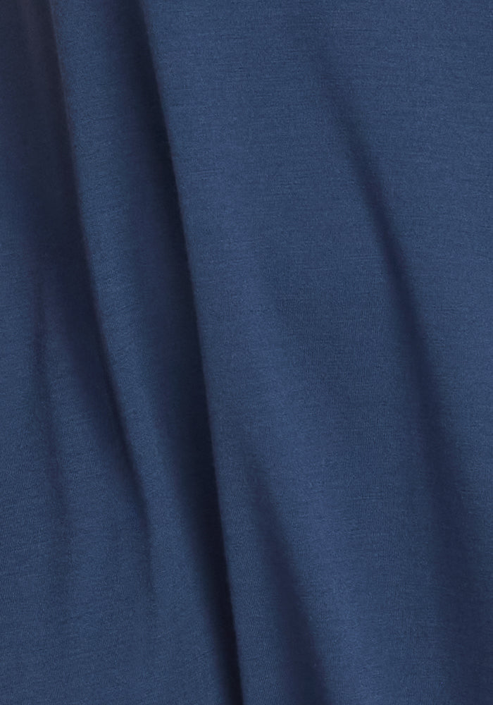 A close-up of the Woolx Rissa A Line Dress in Starry Night shows its smooth merino wool texture and gentle draping—perfect for layering in fall and winter.