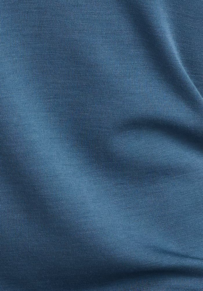 Close-up of the smooth, fine-knit steel blue fabric of the Woolx Easton Crew Neck Shirt—perfect as a merino wool base layer or moisture-wicking long sleeve shirt.