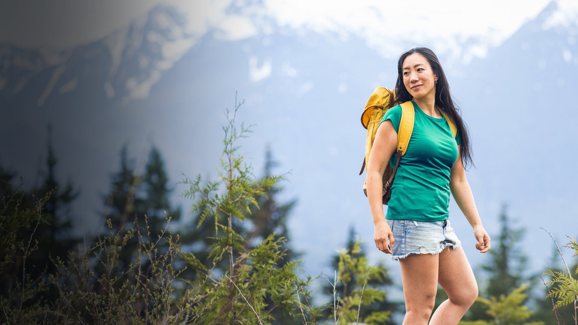 Woman with a backpack hiking in a mountainous area