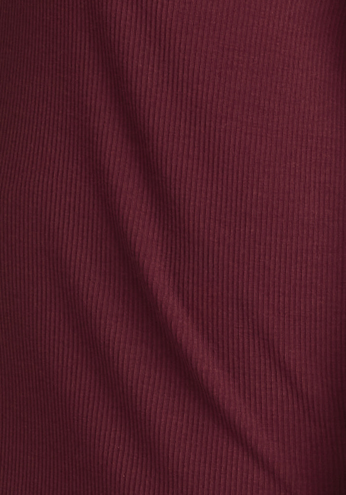 Close-up of the ribbed fabric on the Woolx Ainsley Sweater in Toasted Garnet, highlighting the vertical lines and subtle texture of this premium merino wool knit.