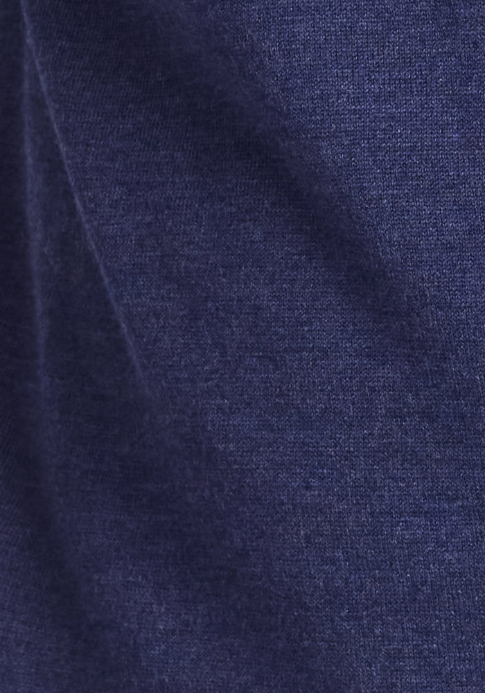 Close-up of the Woolx Enzo Quarter Zip in Twilight Storm shows its dark blue Merino wool fabric with a soft, textured surface—ideal as a midweight layer for moisture-wicking comfort.