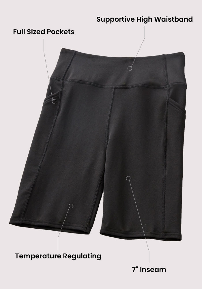 Woolx Merino Flex® Dani Bike Shorts in black, featuring a supportive high waistband, odor resistance, full-sized pockets, temperature-regulating fabric, and a 7-inch inseam, shown on a light background.