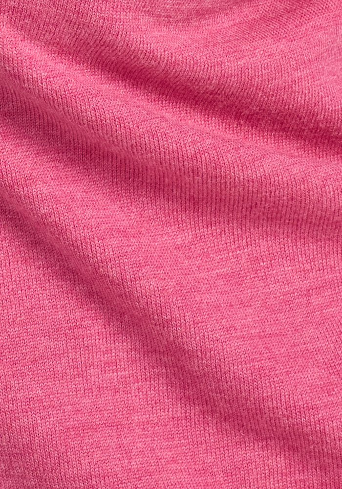 Close-up of the Woolx Anna Crew Sweater in Wild Salmon, showcasing its soft merino wool fabric with visible texture and gentle folds.