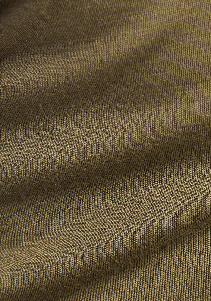Close-up of the Woolx Explorer Base Layer in Winter Moss, featuring fine ribbed knit texture and subtle folds—perfect as a midweight, moisture-wicking merino wool base layer.
