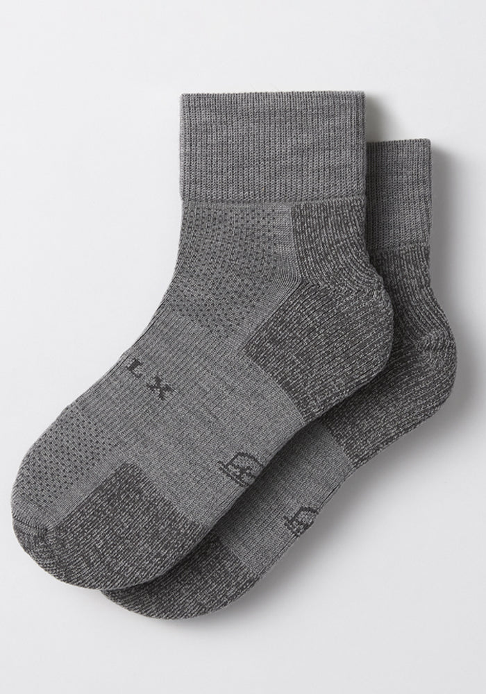 The Woolx Womens Rambler Ankle Sock in Pebble, crafted from Merino wool with ribbed cuffs and textured knit for moisture management, is shown laid flat on a white background.