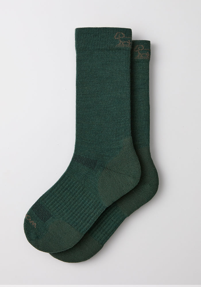A pair of Woolx Mens Harbor Crew Socks in Forest, laid flat on white, ideal for moisture-wicking comfort.