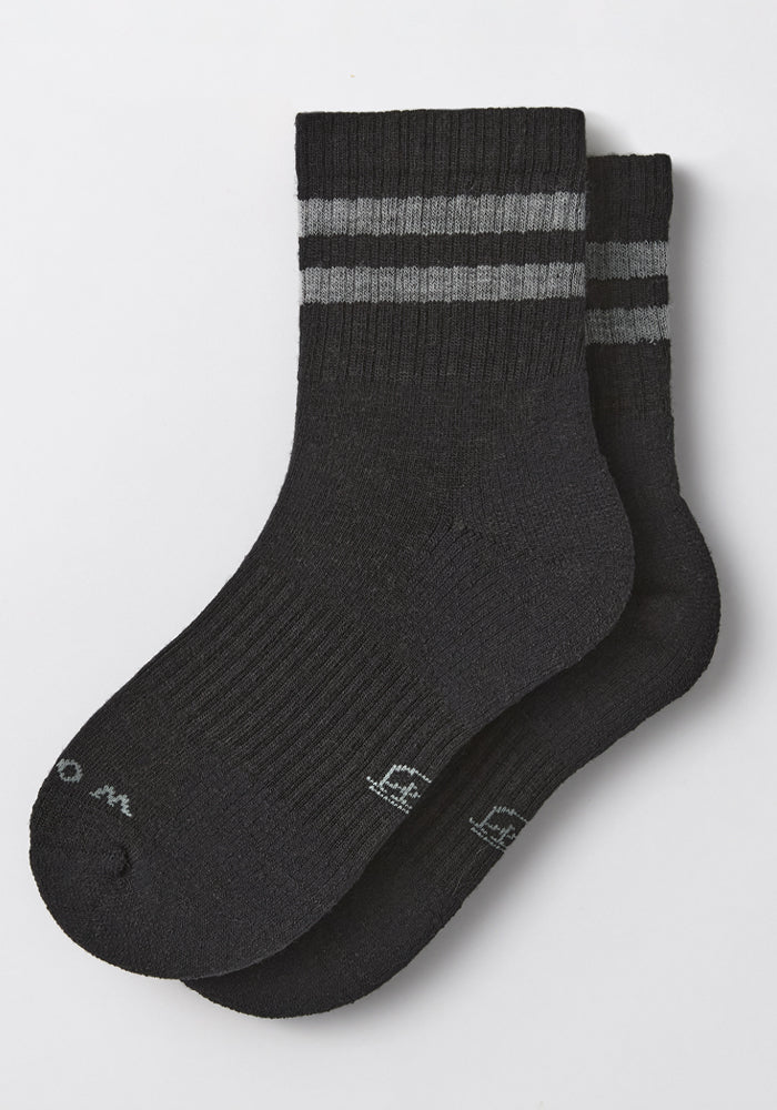 The Woolx Womens Varsity Mini Crew Socks in Black Volt feature two gray stripes near the top, ribbed cuffs, subtle toe lettering, and moisture-wicking comfort. Shown flat on a white background, they're ideal for active wear.