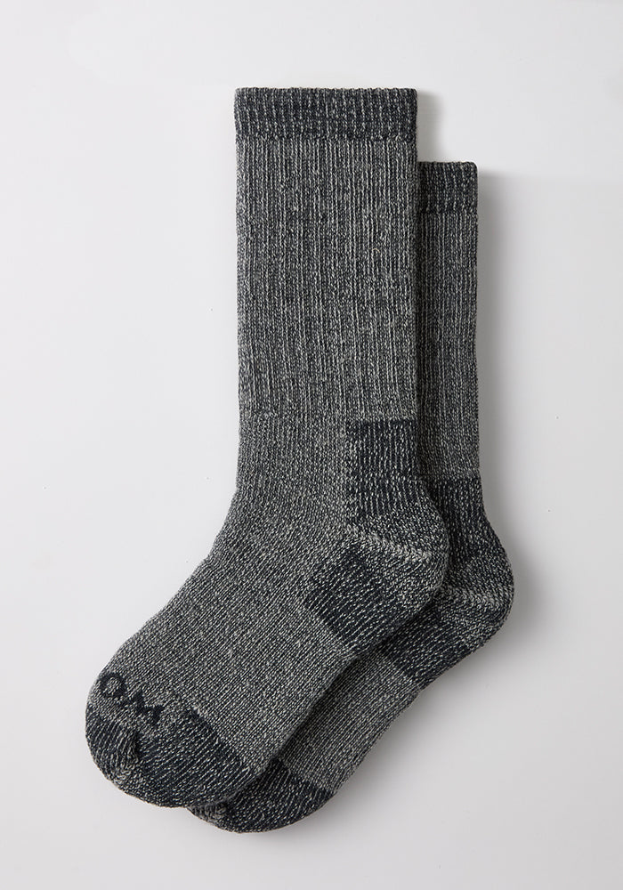 A pair of Woolx Womens Extreme Crew Socks in Charcoal Heather laid flat on a white background.