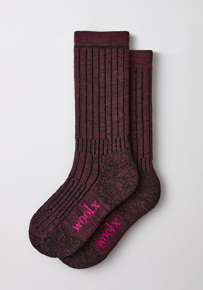 Two Woolx Women’s Joey Mid Calf Socks in Warm Violet, “woolx” in pink on soles, laid flat on white surface.