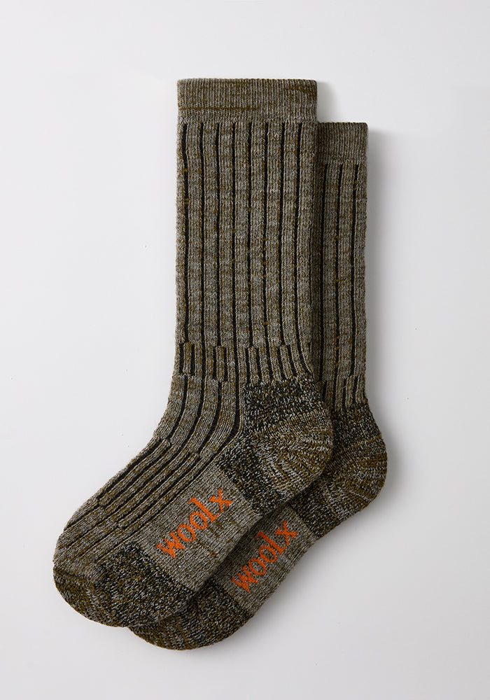 Two pairs of Woolx Men’s Joey Mid Calf Socks in Dark Forest Marled; warm, cozy ribbed socks with orange logo on toes.