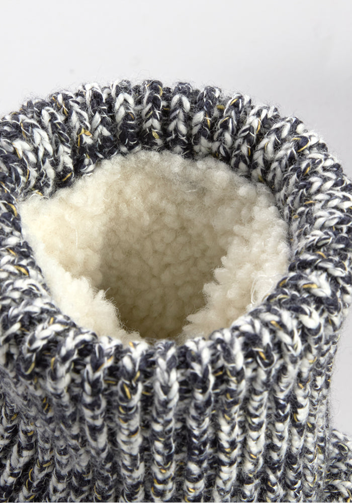 Close-up of Woolx Women’s Gripper Slipper Booties—Speckled Stone—with fuzzy sherpa lining inside the knit opening.