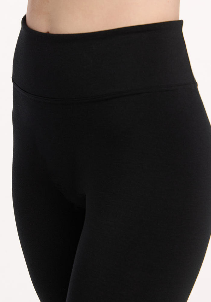 A close-up of a person wearing Woolx Angela Leggings - Black against a plain background.