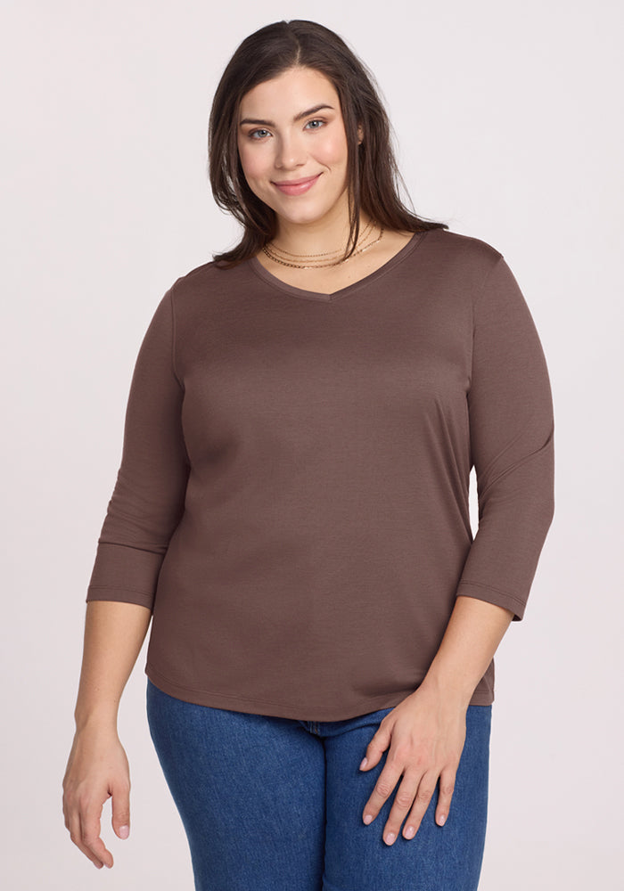 Woman wearing the Woolx Elena 3/4 Sleeve V Neck in Peppercorn and blue jeans, smiling at the camera. 