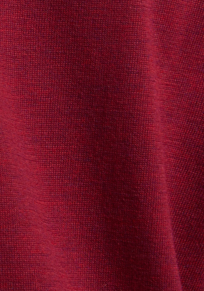 Close-up of the Woolx Caitlin Sweater in Beet Red, featuring textured Merino wool and soft lighting.