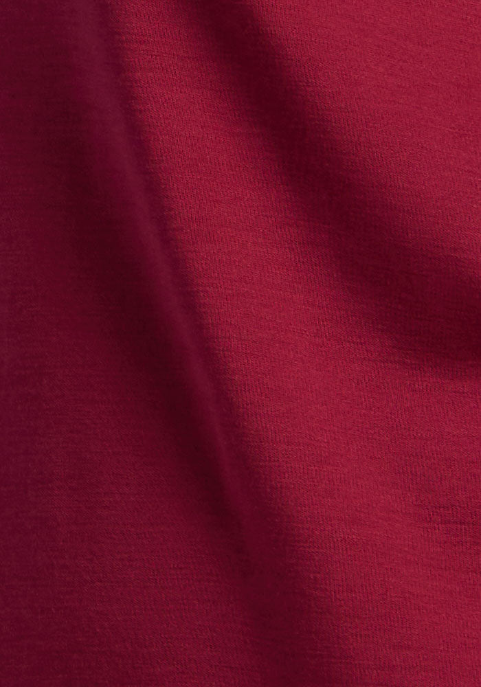 Close-up of Woolx Peyton Turtleneck in Beet Red, premium Merino wool fabric shows texture and softness.