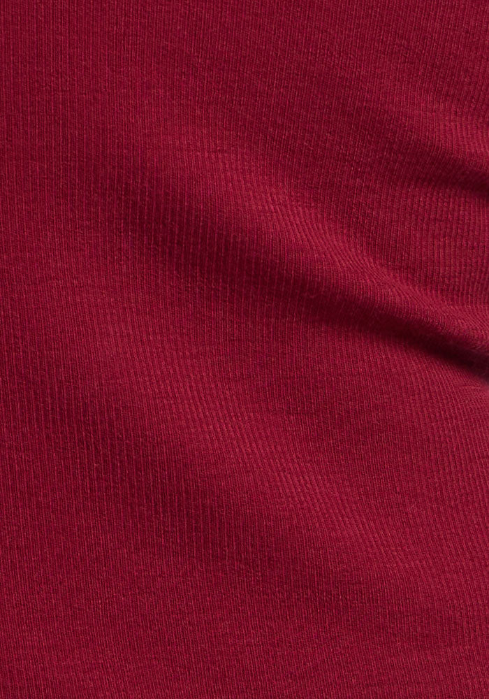 Close-up of Woolx Reese Ribbed Henley in Beet Red, showing its textured Merino fabric and subtle folds.