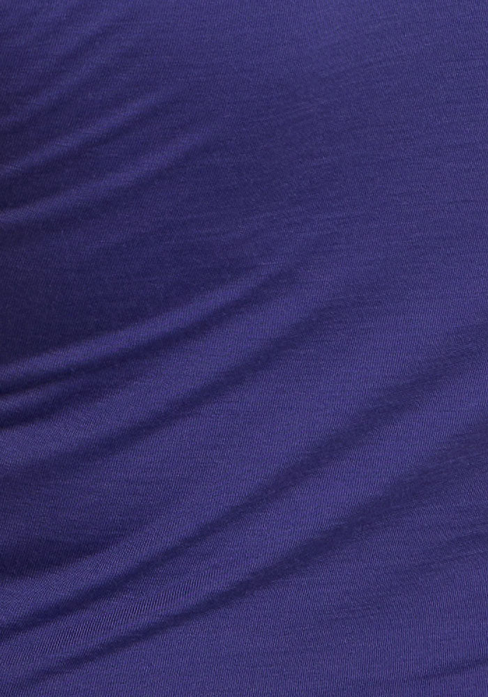 Close-up of Woolx Maggie Bodysuit - Berry Indigo fabric showing its dark blue color, folds, and texture.