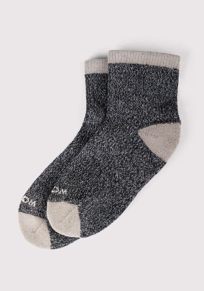 A pair of Woolx Womens Cozy Mini Crew Socks in black with gray speckles and light gray heels, toes, and cuffs, shown side by side on a light background.