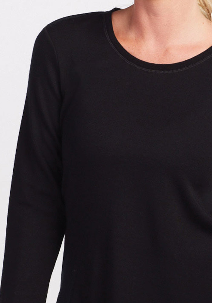 Model wears Woolx Blair Petite Tunic in black; shown shoulders to waist on a white background.