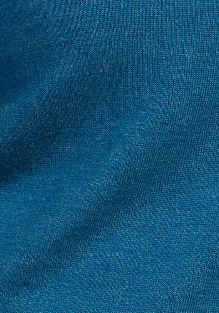 Close-up of Woolx Caitlin Sweater - Blue Pine, showing knit texture and soft Merino wool folds.