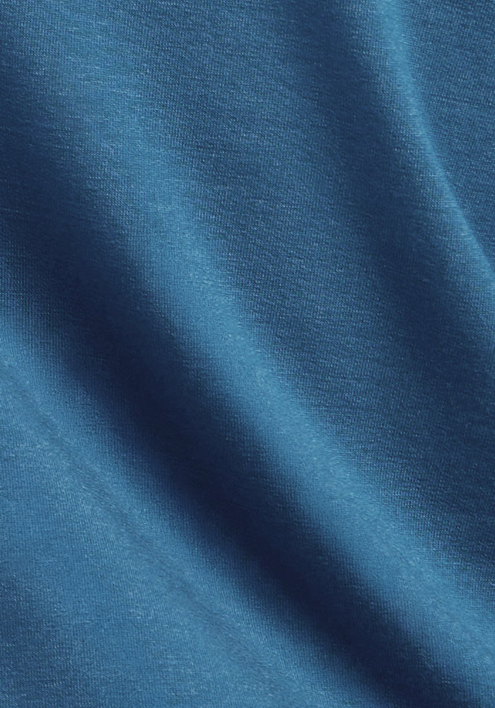 Close-up of Woolx Easton Crew Neck Shirt in Blue Ashes, showing its textured merino wool and soft shadowed folds.